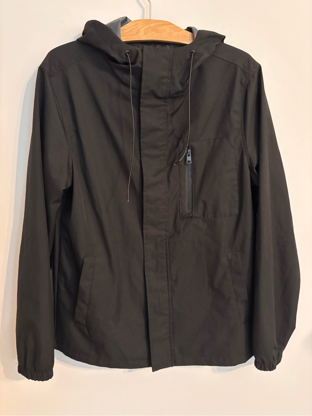 Marc Anthony windbreaker jacket features a black polyester shell